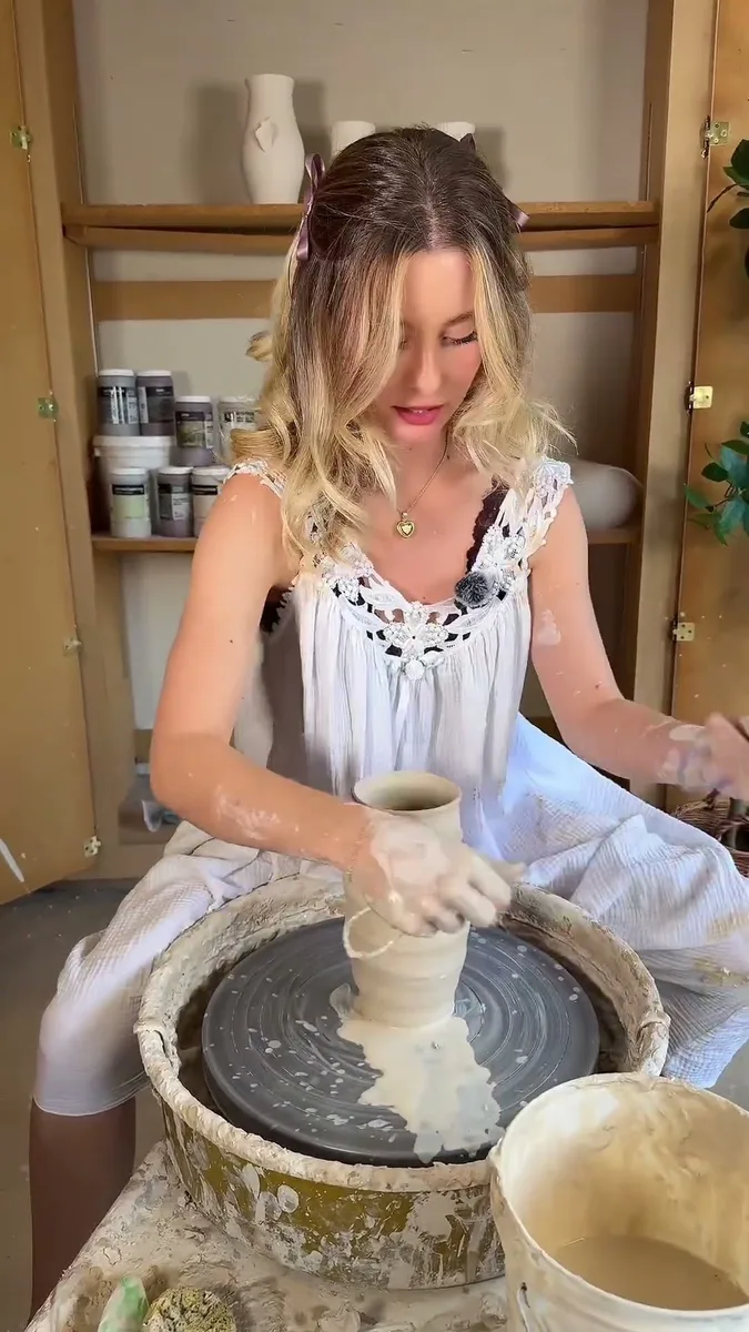 Haven Tunin throwing a cup on the pottery wheel in her studio