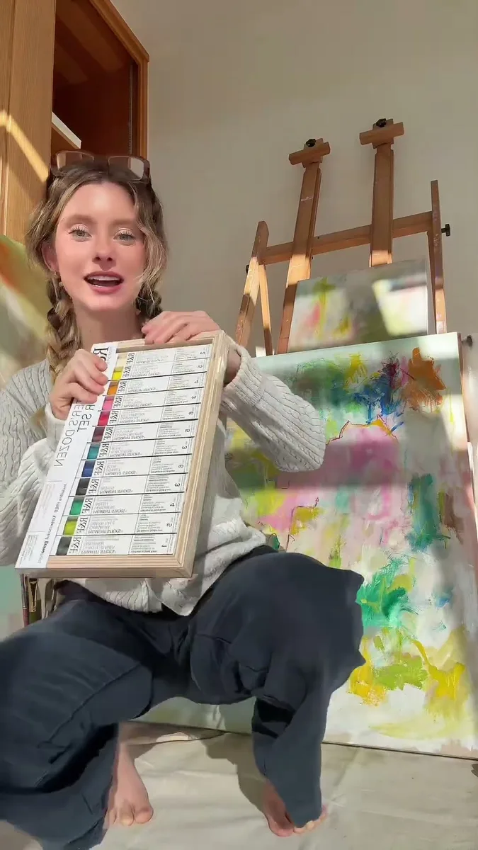 Haven Tunin in her painting studio holding a new set of paint tubes