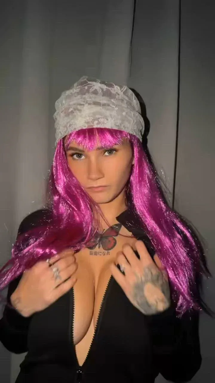 Mchrddx in a pink wig and a lace headband, black zip top